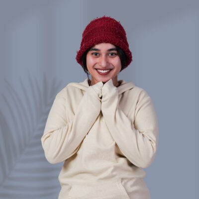 a woman smiling with her hands together