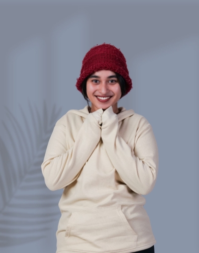 a woman smiling with her hands together